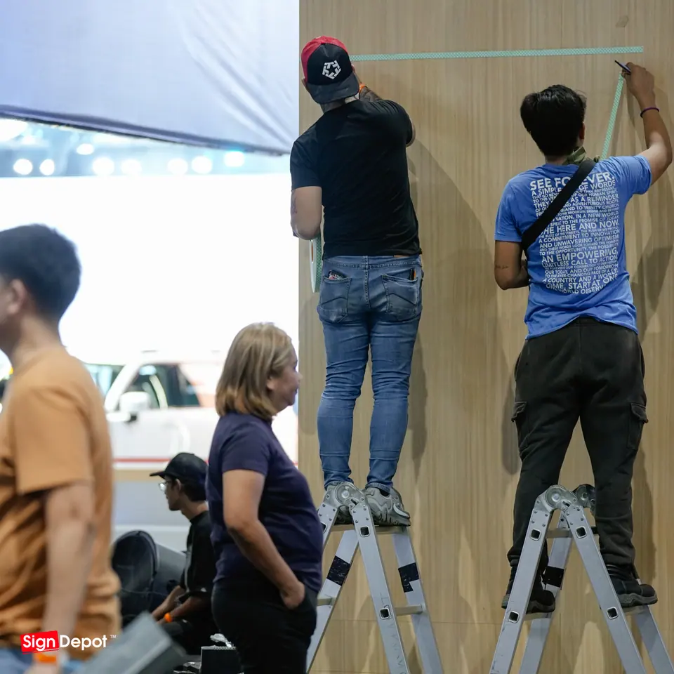 Installers on ladders finish a timber wall