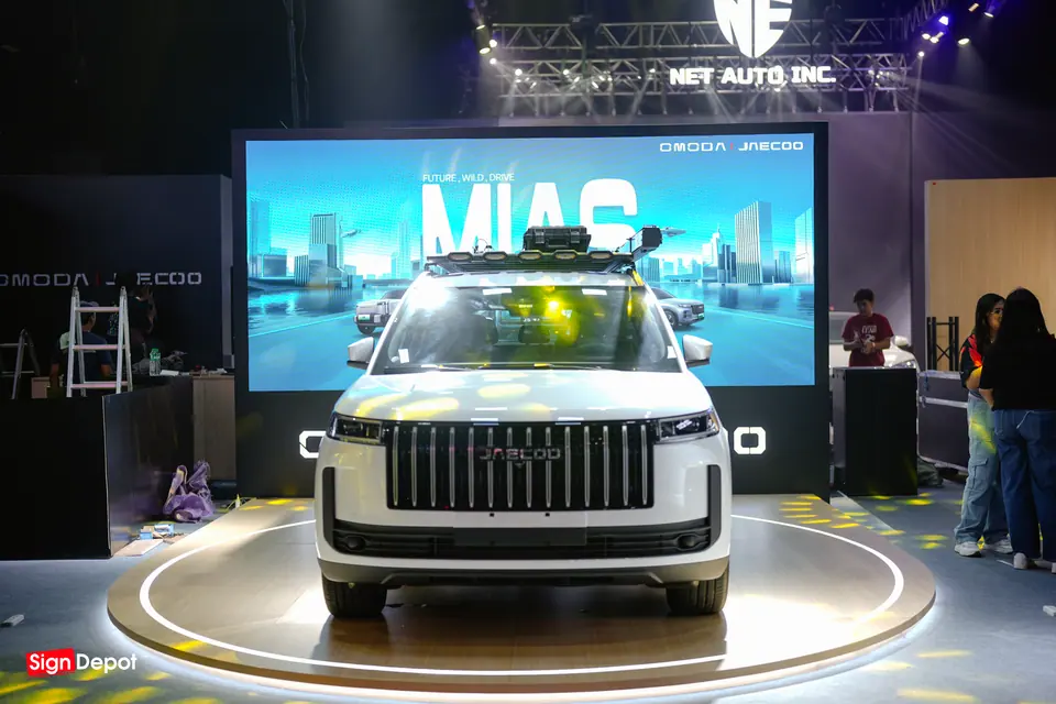A display SUV on a lit turntable in front of the LED wall