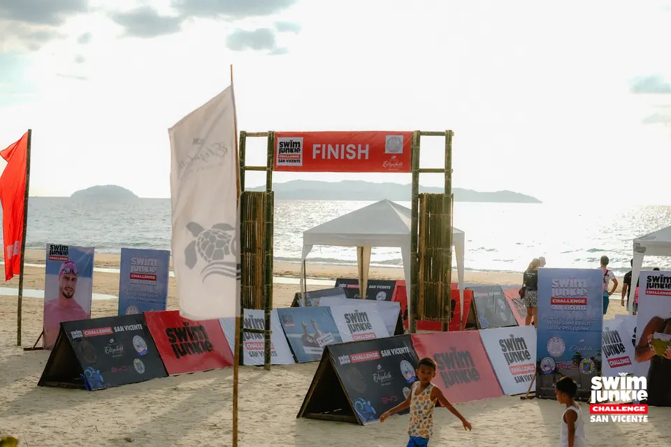 The finish gate and sponsor boards on the beach